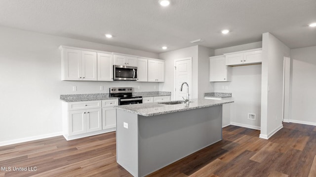 9613 Reserve Blvd, Biloxi, MS 39532 - kitchen with appliances with stainless steel finishes, white cabinets, a center island with sink, recessed lighting, and dark wood finished floors