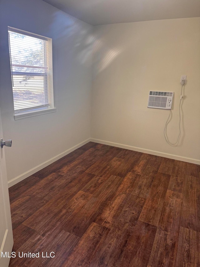 unfurnished room with an AC wall unit, dark wood-type flooring, and vaulted ceiling