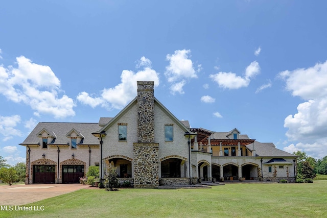 11281 Rd 468, Philadelphia, MS 39350 - view of front of home featuring a garage, a front yard, and a balcony