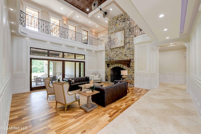 11281 Rd 468, Philadelphia, MS 39350 - living room with crown molding, a fireplace, light hardwood / wood-style floors, french doors, and ornate columns