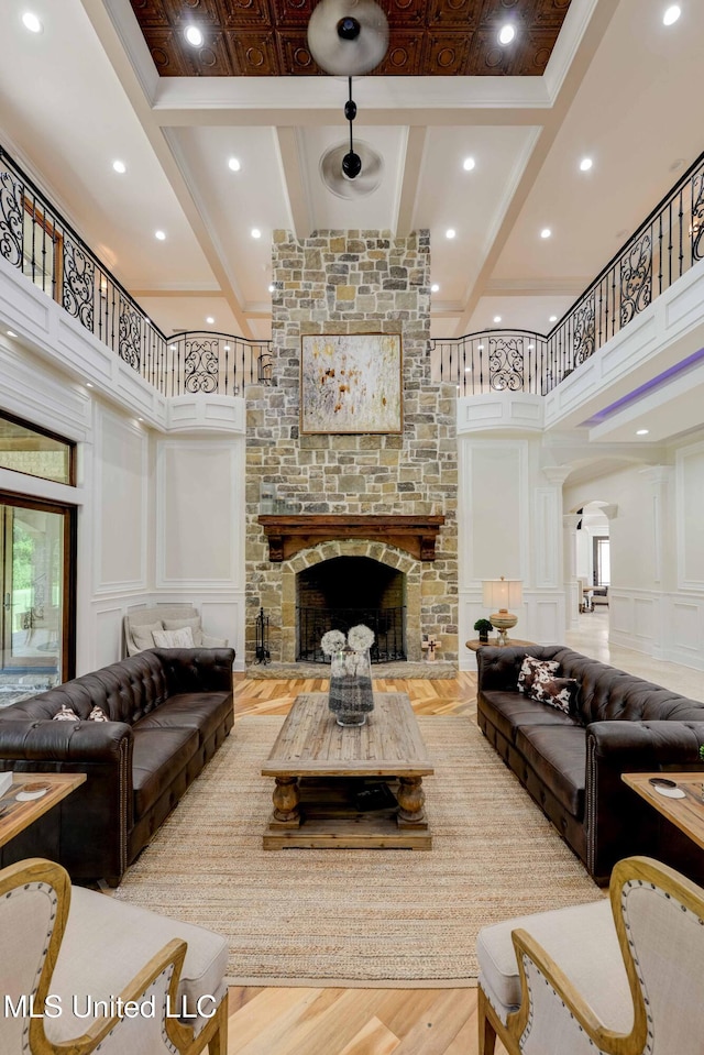 11281 Rd 468, Philadelphia, MS 39350 - living room featuring beamed ceiling, a high ceiling, hardwood / wood-style floors, and a fireplace