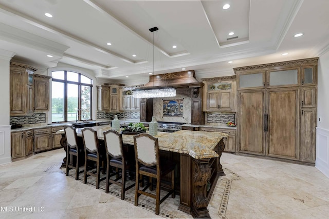 11281 Rd 468, Philadelphia, MS 39350 - kitchen featuring a raised ceiling, custom exhaust hood, light stone counters, and a spacious island