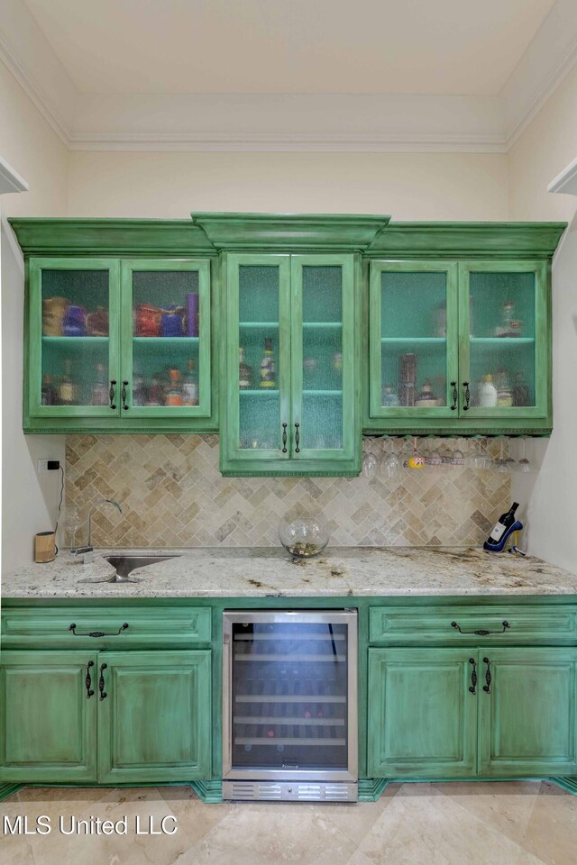 11281 Rd 468, Philadelphia, MS 39350 - bar with light stone counters, green cabinetry, beverage cooler, and decorative backsplash