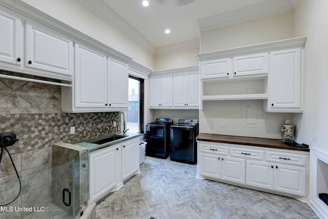 11281 Rd 468, Philadelphia, MS 39350 - kitchen featuring sink, white cabinetry, ornamental molding, washer and dryer, and light parquet flooring