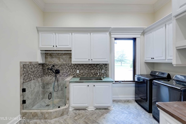 11281 Rd 468, Philadelphia, MS 39350 - clothes washing area with cabinets, washing machine and dryer, sink, and ornamental molding