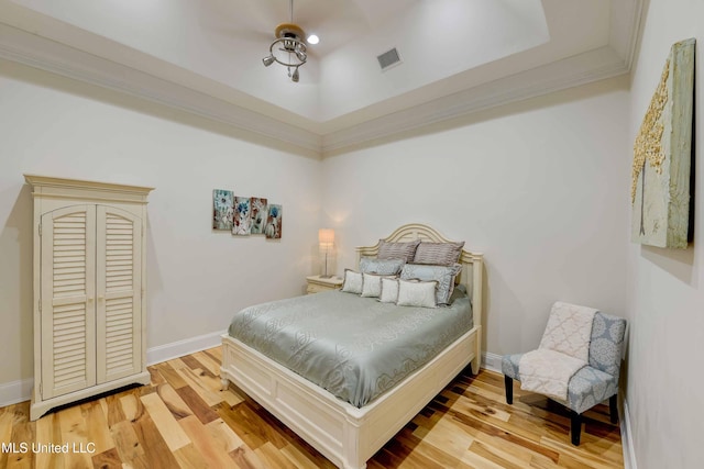11281 Rd 468, Philadelphia, MS 39350 - bedroom with hardwood / wood-style floors, a tray ceiling, and ornamental molding