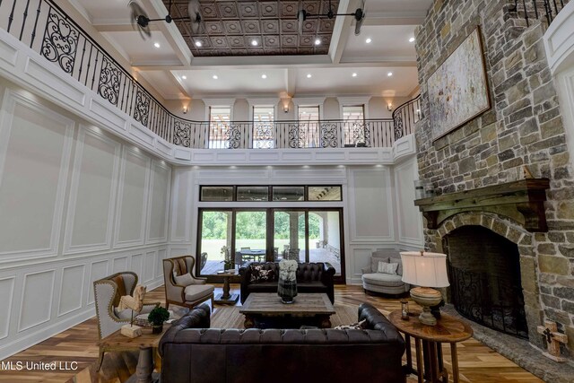 11281 Rd 468, Philadelphia, MS 39350 - living room featuring beamed ceiling, a towering ceiling, hardwood / wood-style floors, and a fireplace