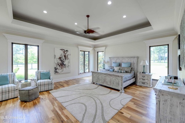 11281 Rd 468, Philadelphia, MS 39350 - bedroom featuring a tray ceiling, multiple windows, and light wood-type flooring