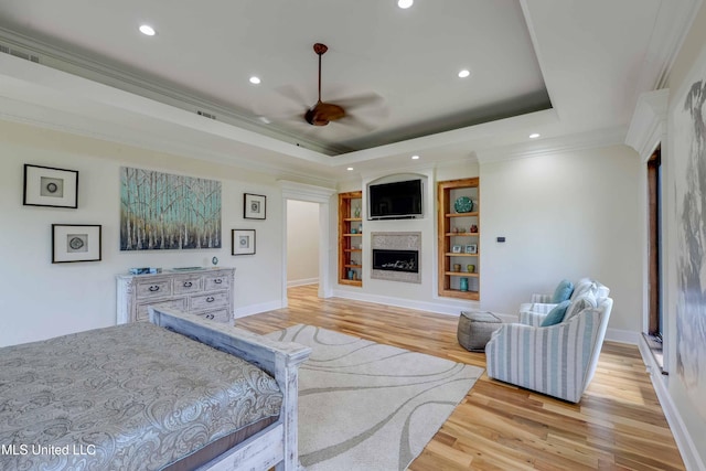 11281 Rd 468, Philadelphia, MS 39350 - bedroom featuring a tray ceiling, ornamental molding, light hardwood / wood-style floors, and ceiling fan