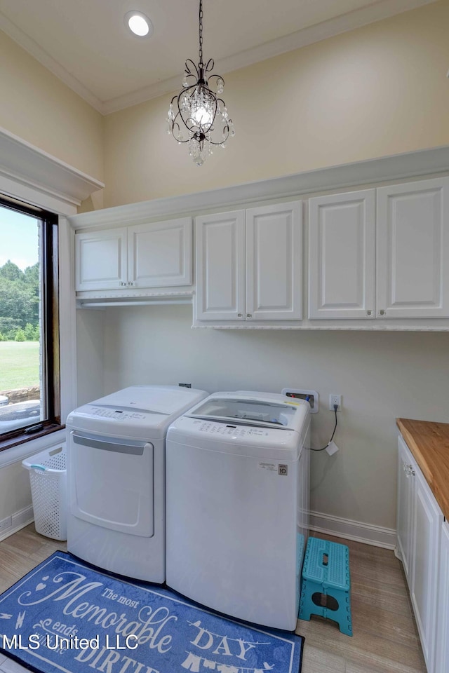 11281 Rd 468, Philadelphia, MS 39350 - washroom featuring a chandelier, cabinets, ornamental molding, light hardwood / wood-style floors, and washer and clothes dryer