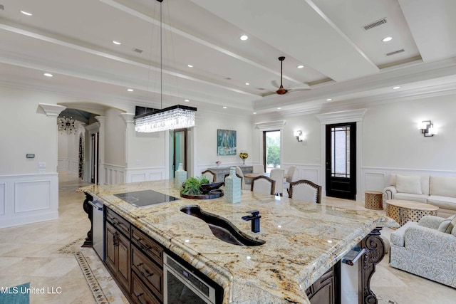 11281 Rd 468, Philadelphia, MS 39350 - kitchen with black electric stovetop, decorative light fixtures, light stone countertops, and a kitchen bar