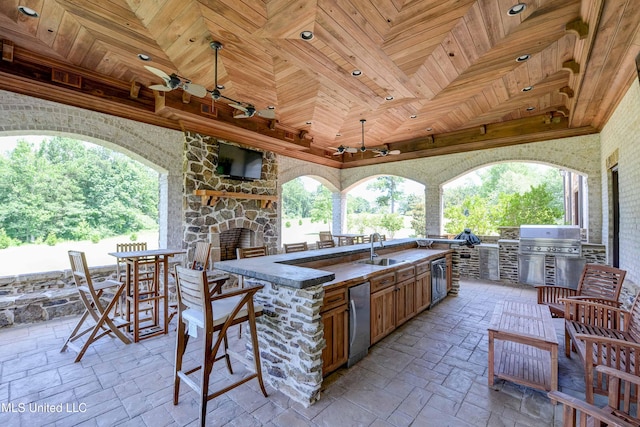 11281 Rd 468, Philadelphia, MS 39350 - view of patio / terrace featuring sink, ceiling fan, an outdoor stone fireplace, area for grilling, and an outdoor kitchen