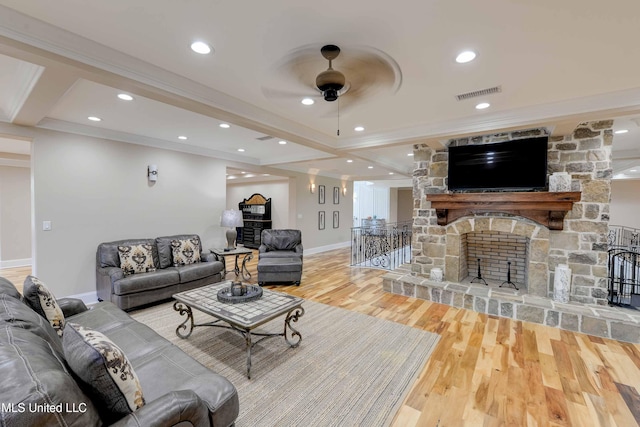 11281 Rd 468, Philadelphia, MS 39350 - living room featuring a stone fireplace, ornamental molding, ceiling fan, beam ceiling, and hardwood / wood-style floors
