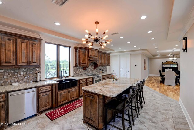 11281 Rd 468, Philadelphia, MS 39350 - kitchen featuring sink, decorative backsplash, a center island, stainless steel appliances, and light stone countertops