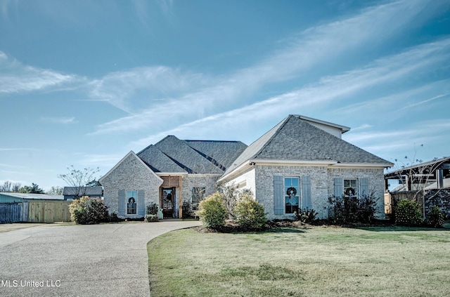 french country style house with a front lawn