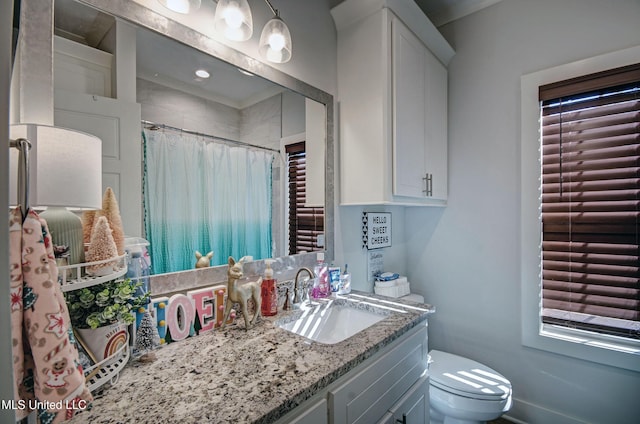 bathroom with toilet, curtained shower, and vanity