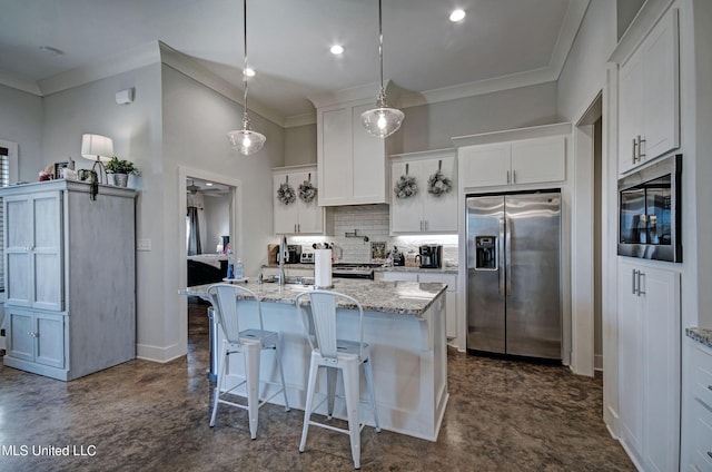 kitchen with stainless steel appliances, white cabinets, backsplash, an island with sink, and crown molding