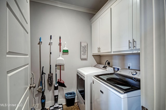 laundry area with cabinet space, washer and clothes dryer, and baseboards