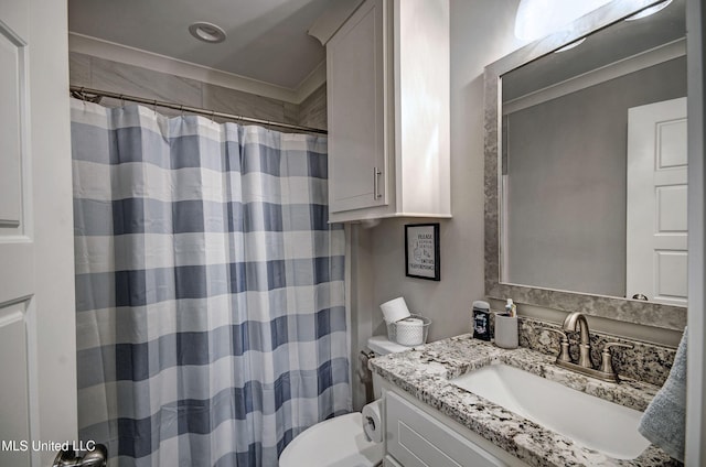 bathroom featuring curtained shower, vanity, and toilet