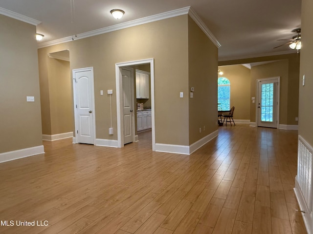 spare room with crown molding, ceiling fan, and light wood-type flooring