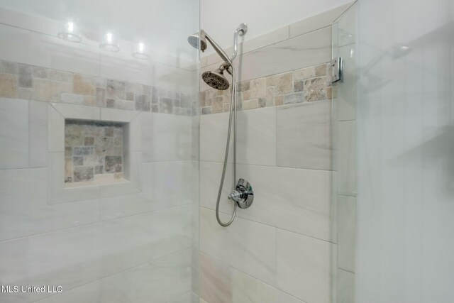 full bath featuring a shower stall