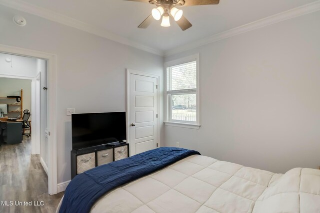 bedroom with ceiling fan, baseboards, wood finished floors, and ornamental molding