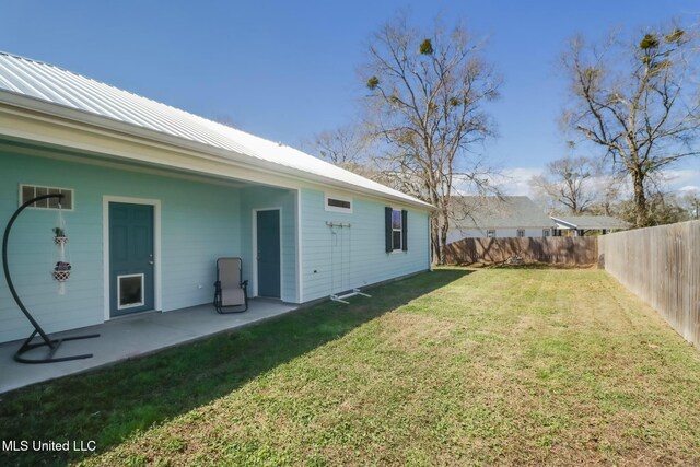 view of yard featuring a patio area and a fenced backyard