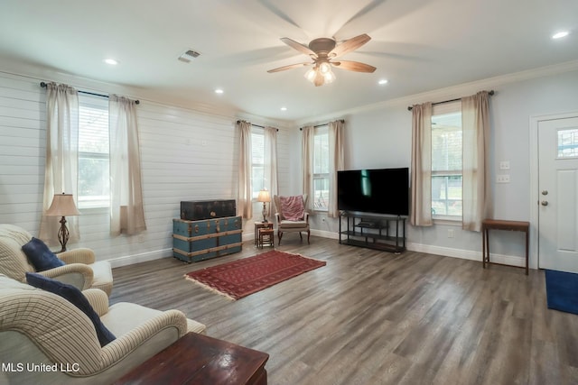 living room with wood finished floors, visible vents, a wealth of natural light, and ceiling fan