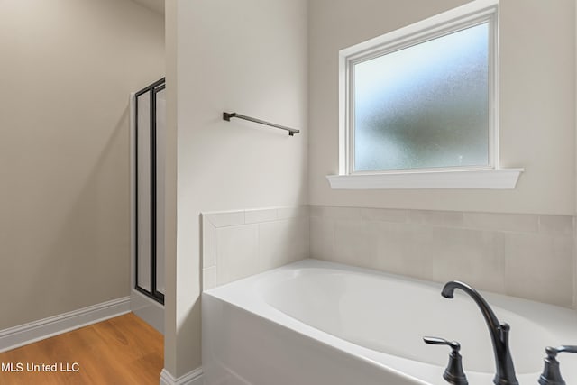 bathroom with separate shower and tub and hardwood / wood-style floors