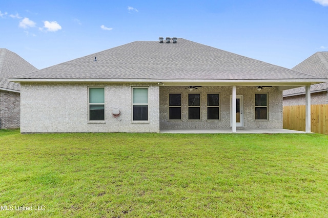 back of property with a patio area, a lawn, and ceiling fan