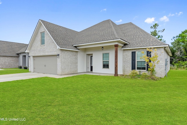 view of front of home featuring a garage and a front lawn