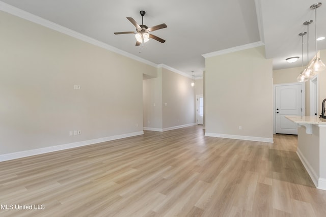 unfurnished living room featuring light hardwood / wood-style flooring, ceiling fan, and crown molding