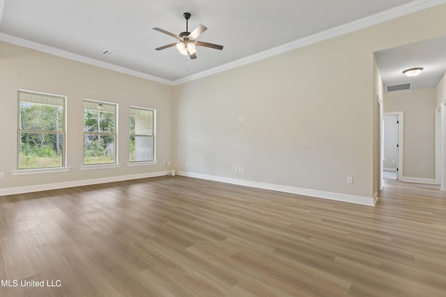 empty room featuring light hardwood / wood-style flooring, ornamental molding, and ceiling fan