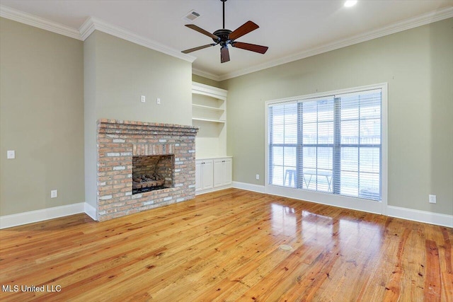 unfurnished living room featuring ceiling fan, light hardwood / wood-style flooring, crown molding, and a brick fireplace