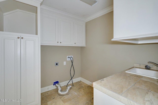 laundry area with electric dryer hookup, sink, cabinets, and ornamental molding