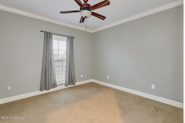 empty room with crown molding, carpet, and ceiling fan