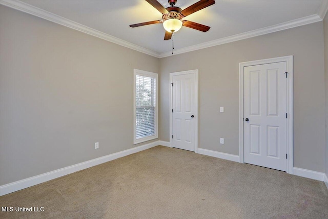 unfurnished bedroom featuring light carpet, ceiling fan, and crown molding