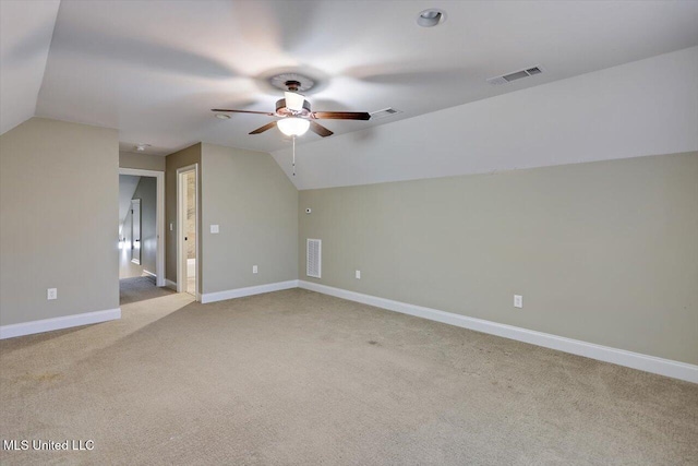 additional living space featuring ceiling fan, light carpet, and lofted ceiling