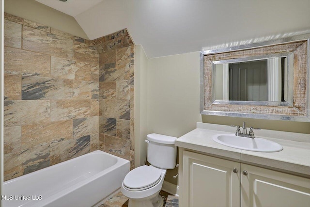 full bathroom featuring tiled shower / bath combo, vanity, toilet, and lofted ceiling