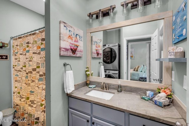 1130 Century Oaks Dr Unit B, Gulfport, MS 39507 - bathroom with stacked washing machine and dryer, vanity, and ensuite bathroom