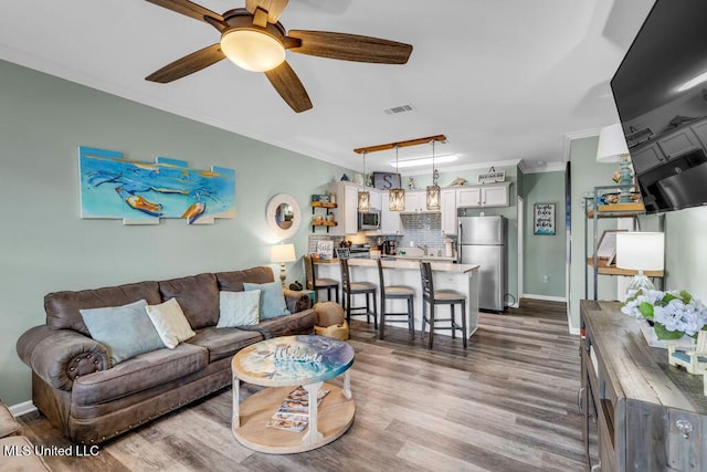 1130 Century Oaks Dr Unit B, Gulfport, MS 39507 - living room featuring ceiling fan, wood finished floors, and crown molding