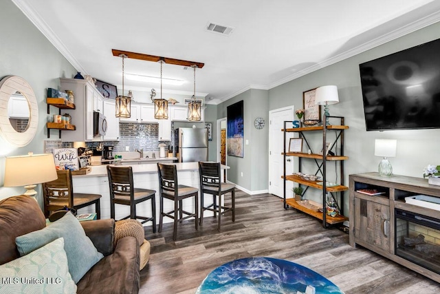 1130 Century Oaks Dr Unit B, Gulfport, MS 39507 - living area with crown molding and dark wood-style flooring