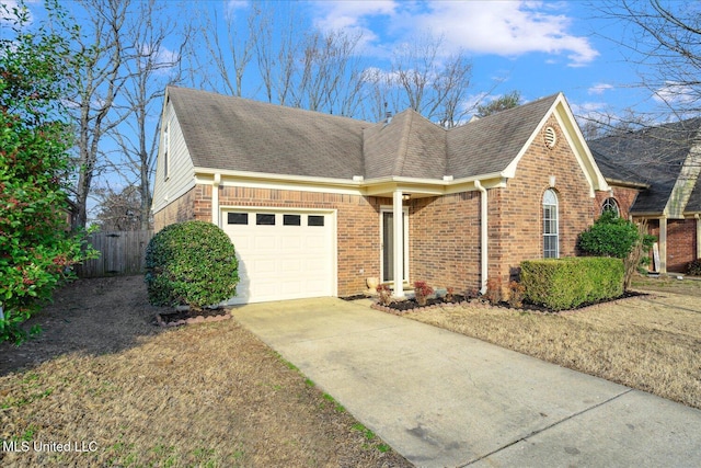 view of front facade with a garage, driveway, roof with shingles, and brick siding