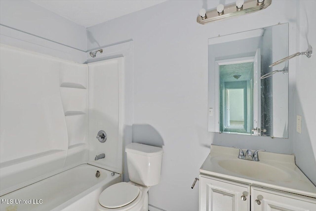 bathroom featuring toilet, vanity, and  shower combination