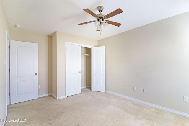 unfurnished bedroom with a ceiling fan, a closet, light colored carpet, and baseboards