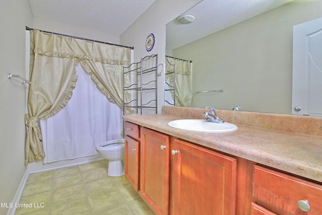 bathroom with a textured ceiling, toilet, vanity, and tile patterned floors