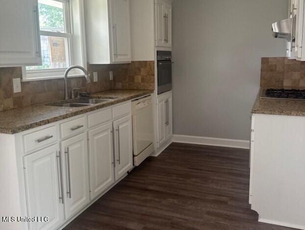 106 Woodcliff Pl, Brandon, MS 39042 - kitchen with white dishwasher, oven, stainless steel gas stovetop, dark wood finished floors, and white cabinets