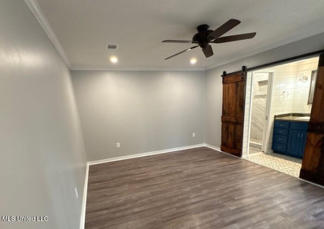 106 Woodcliff Pl, Brandon, MS 39042 - unfurnished bedroom with a barn door, dark wood-style floors, crown molding, recessed lighting, and ensuite bath