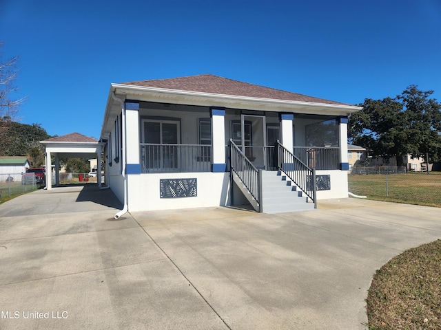 view of front of home with a carport and a porch