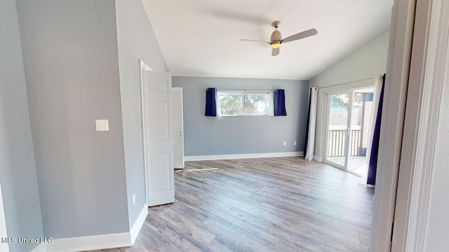 empty room with vaulted ceiling, ceiling fan, and light wood-type flooring